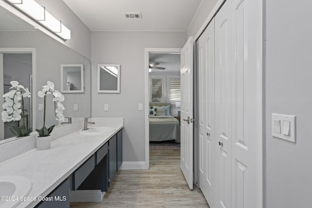 bathroom featuring hardwood / wood-style floors, vanity, and ceiling fan