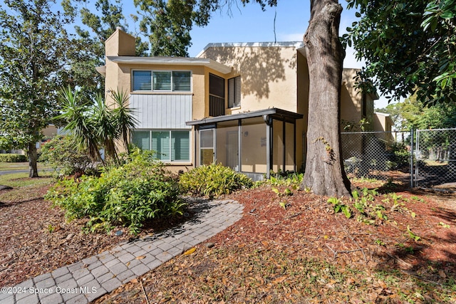 back of property featuring a sunroom