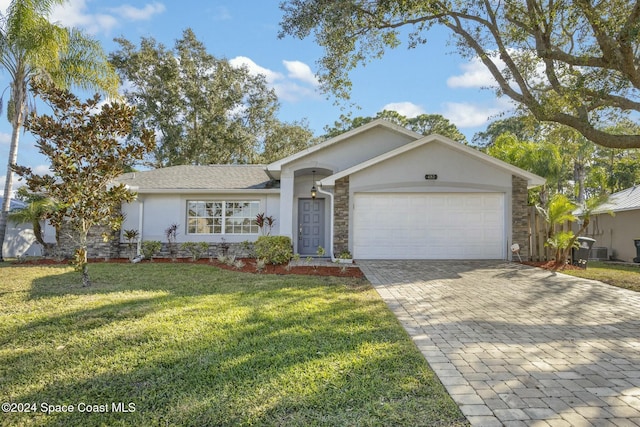 ranch-style home with a garage and a front lawn