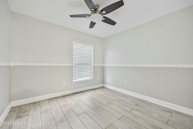 empty room with ceiling fan and light hardwood / wood-style flooring