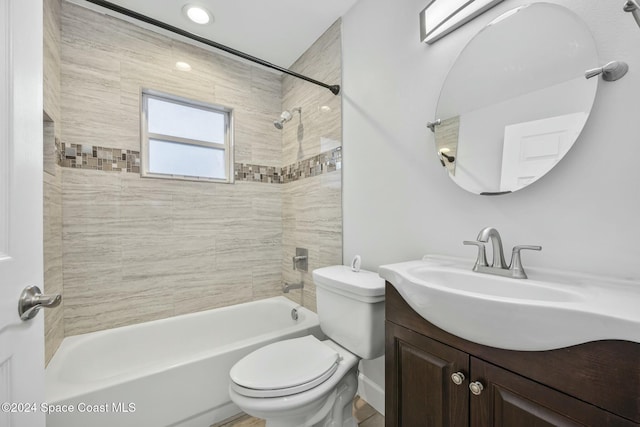 full bathroom with vanity, toilet, and tiled shower / bath