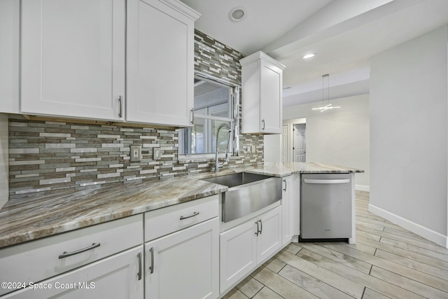 kitchen featuring dishwasher, white cabinets, and sink