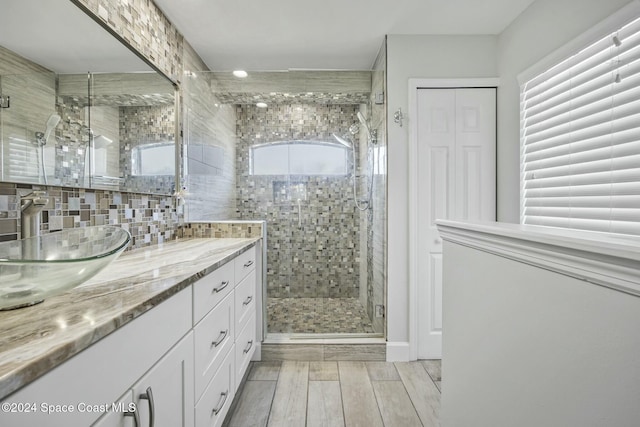 bathroom featuring wood-type flooring, vanity, and plenty of natural light