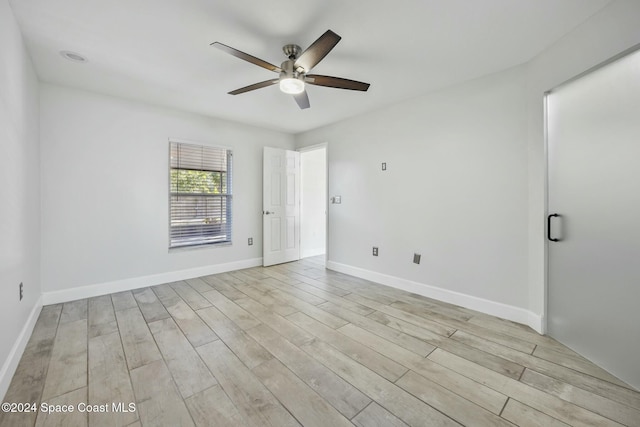 spare room featuring light hardwood / wood-style floors and ceiling fan