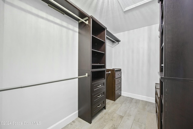 walk in closet with light wood-type flooring