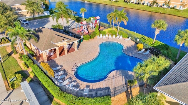 view of swimming pool featuring a water view and a patio area