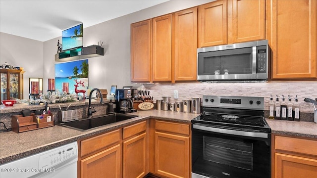 kitchen featuring stainless steel appliances, tasteful backsplash, and sink