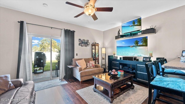 living room featuring ceiling fan and dark wood-type flooring