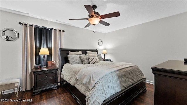 bedroom featuring ceiling fan and dark wood-type flooring