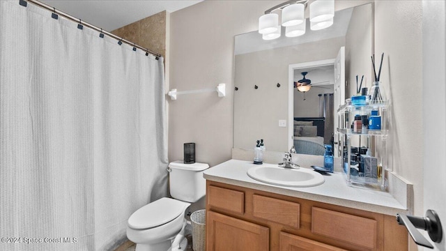 bathroom featuring vanity, toilet, and ceiling fan