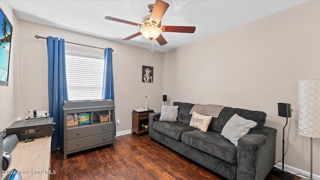 living room featuring ceiling fan and dark wood-type flooring