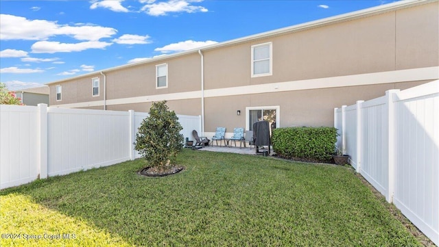 back of property with a patio and a lawn