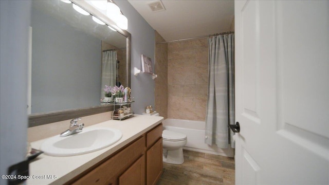 full bathroom with shower / bathtub combination with curtain, vanity, wood-type flooring, and toilet