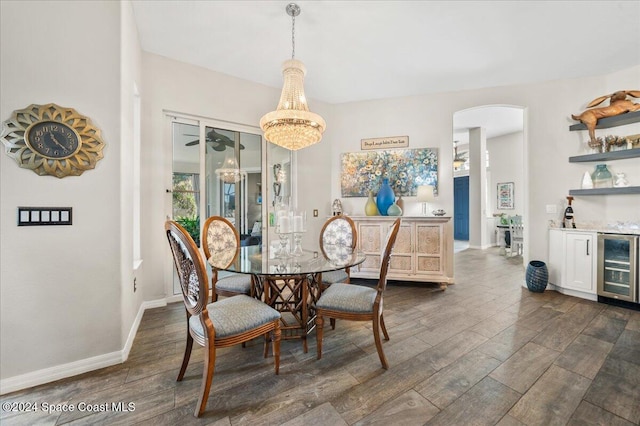 dining area featuring a chandelier, dark hardwood / wood-style flooring, beverage cooler, and bar area