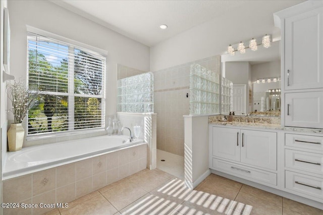 bathroom with vanity, tile patterned flooring, plus walk in shower, and a healthy amount of sunlight