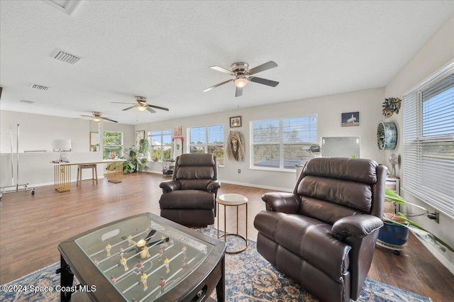 living room with wood-type flooring and a textured ceiling