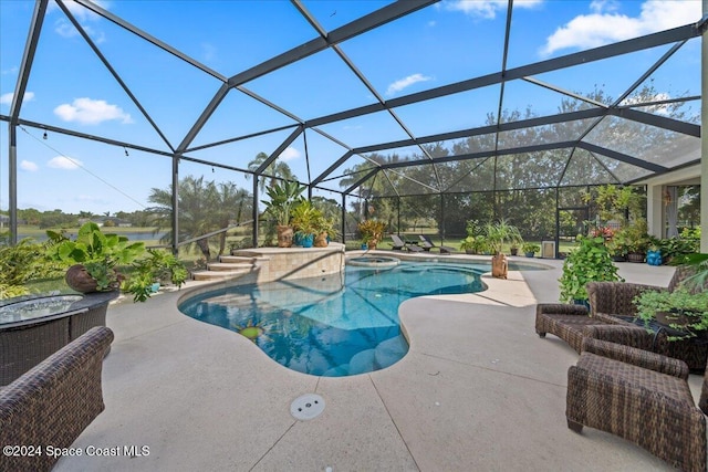 view of swimming pool with a lanai, a patio, and an in ground hot tub