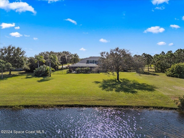 view of property's community featuring a water view and a lawn