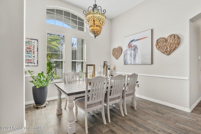 dining area with a chandelier, dark wood-type flooring, and a healthy amount of sunlight