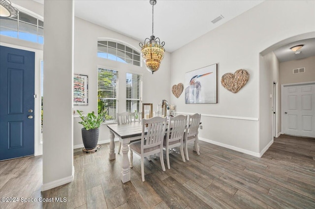 dining room featuring dark wood-type flooring and a notable chandelier