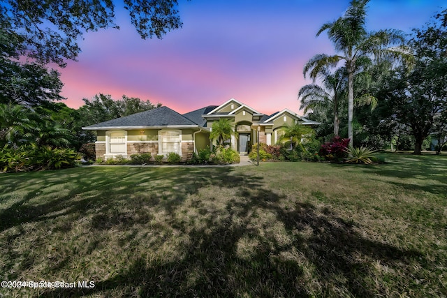 view of front of house with a yard