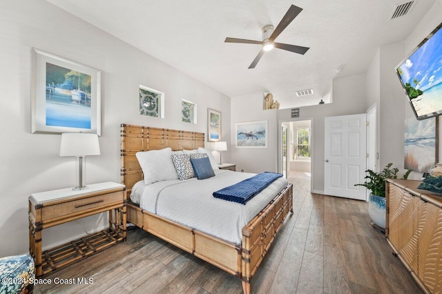 bedroom with connected bathroom, ceiling fan, and dark hardwood / wood-style floors