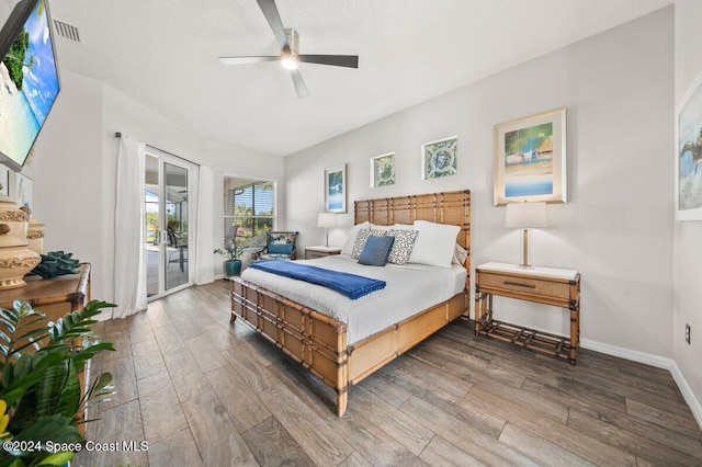 bedroom with hardwood / wood-style flooring, ceiling fan, and access to exterior