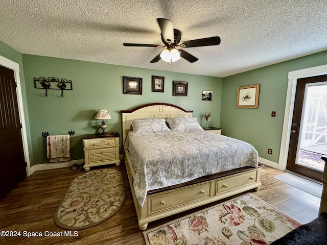 bedroom featuring access to outside, ceiling fan, a textured ceiling, and hardwood / wood-style flooring