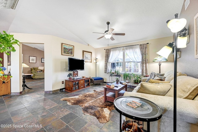 living room featuring vaulted ceiling and ceiling fan