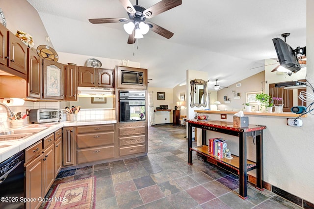 kitchen featuring tasteful backsplash, sink, black appliances, tile countertops, and lofted ceiling