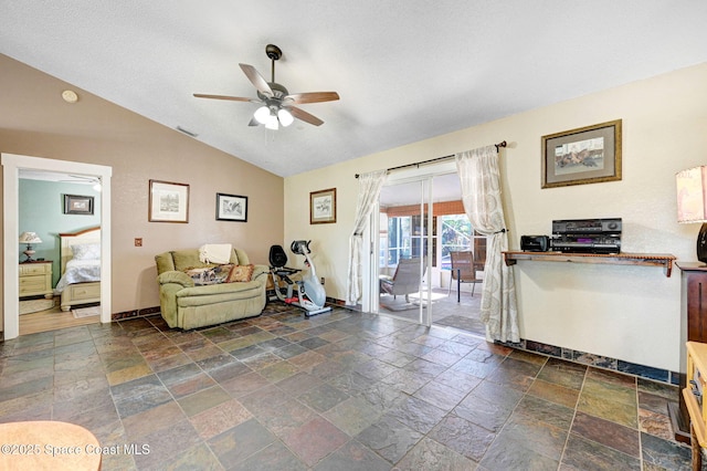 living room featuring a textured ceiling, ceiling fan, and lofted ceiling