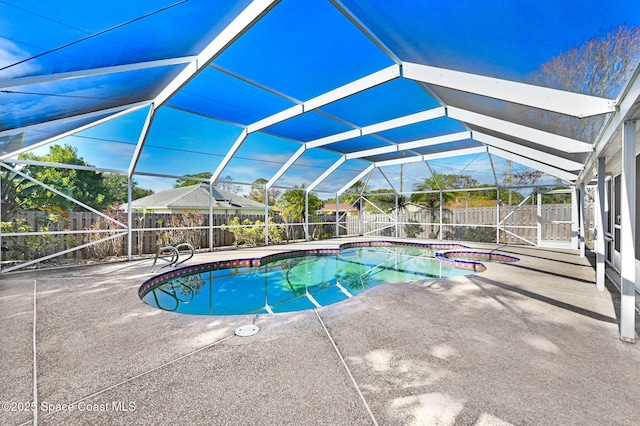 view of swimming pool with a lanai, a patio, and a hot tub