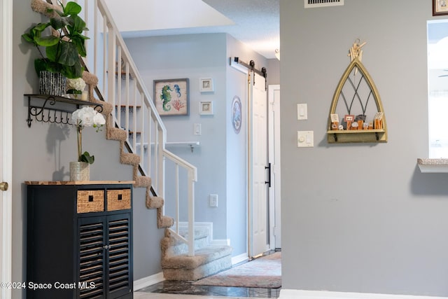 entrance foyer with a barn door