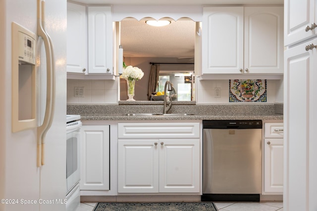 737 Palm Springs Cir, Indian Harbour Beach, FL 32937 - kitchen with dishwasher, white fridge with ice dispenser, tasteful backsplash, light tile patterned floors, and white cabinets