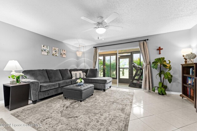 737 Palm Springs Cir, Indian Harbour Beach, FL 32937 - living room with a ceiling fan, light tile patterned flooring, and a textured ceiling