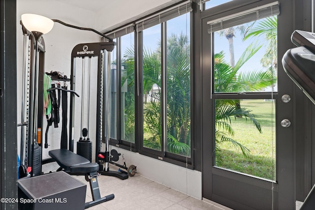 737 Palm Springs Cir, Indian Harbour Beach, FL 32937 - exercise room with healthy amount of natural light and tile patterned flooring