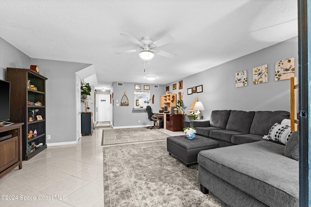 tiled living room featuring a textured ceiling and ceiling fan