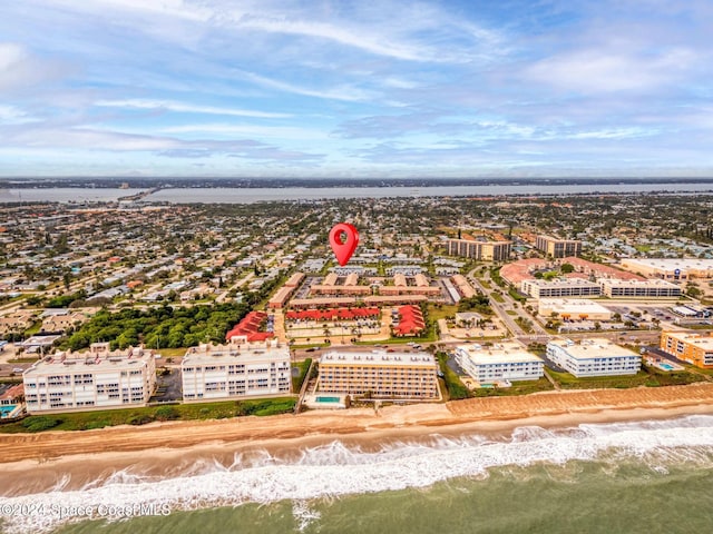 bird's eye view with a water view and a view of the beach