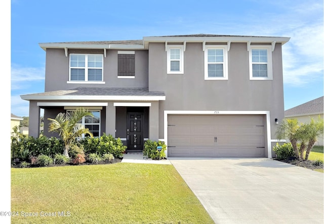 view of front of house with a garage and a front lawn