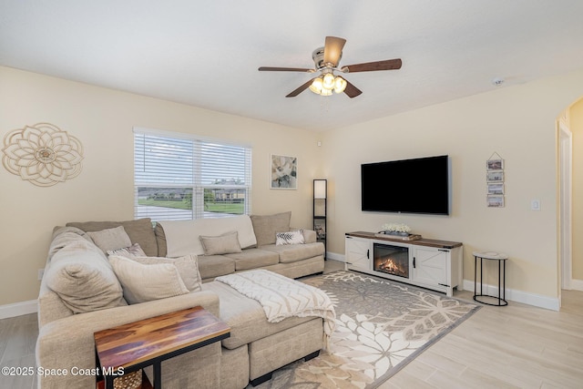 living room with ceiling fan and light hardwood / wood-style floors