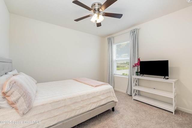 bedroom with ceiling fan and light carpet