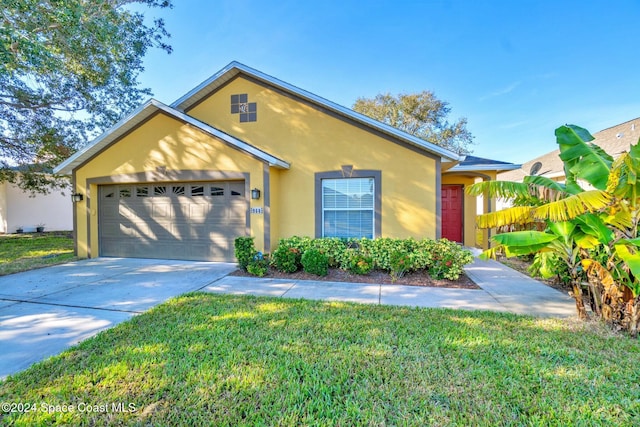 view of front of property with a garage and a front lawn