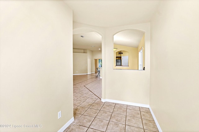 corridor featuring light tile patterned floors