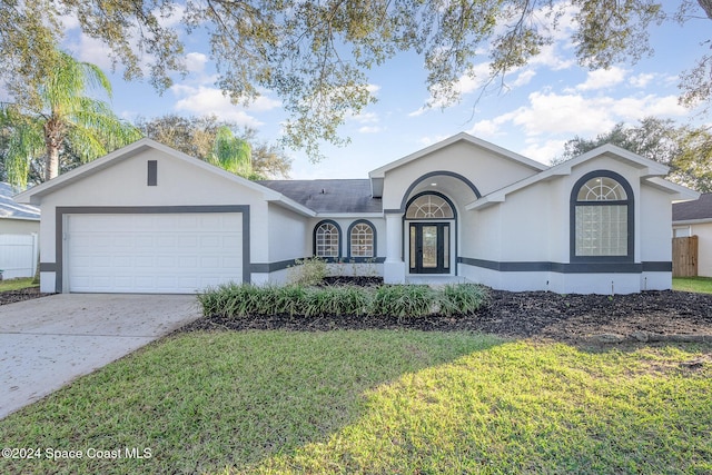 single story home with a front yard and a garage