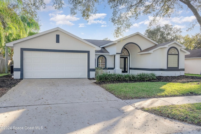 single story home with a garage and a front lawn