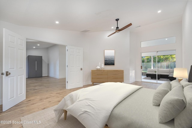 bedroom featuring ceiling fan, light hardwood / wood-style flooring, and vaulted ceiling