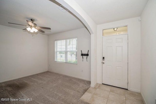 carpeted entrance foyer featuring ceiling fan