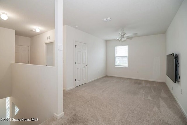 carpeted empty room with ceiling fan