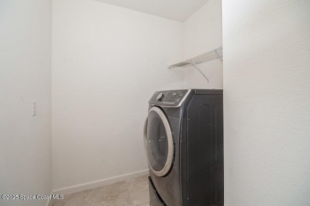 clothes washing area with washer / dryer