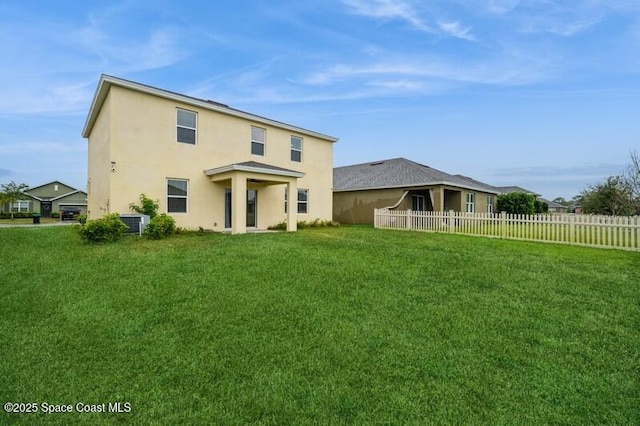 rear view of house with a yard